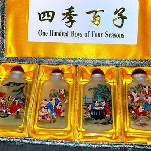 Hand painted snuff bottle set of 4. Original box included.
